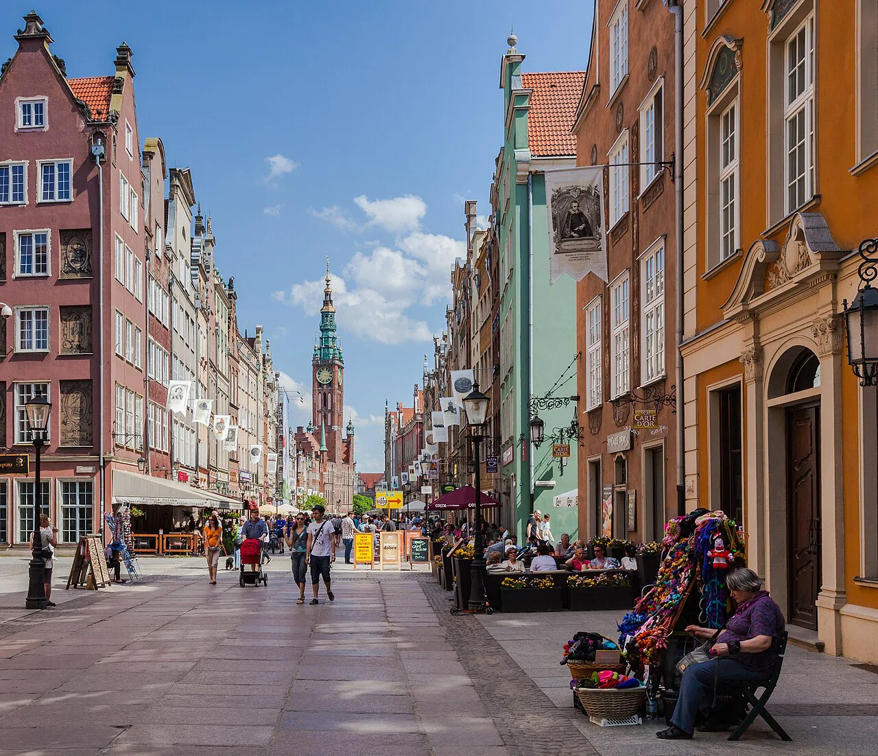 Terrace cafés on Długa Street with the Main Town Hall tower in Gdańsk.