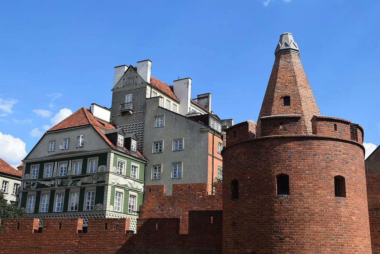 A tower of the Barbican with Old Town houses behind in Warsaw.