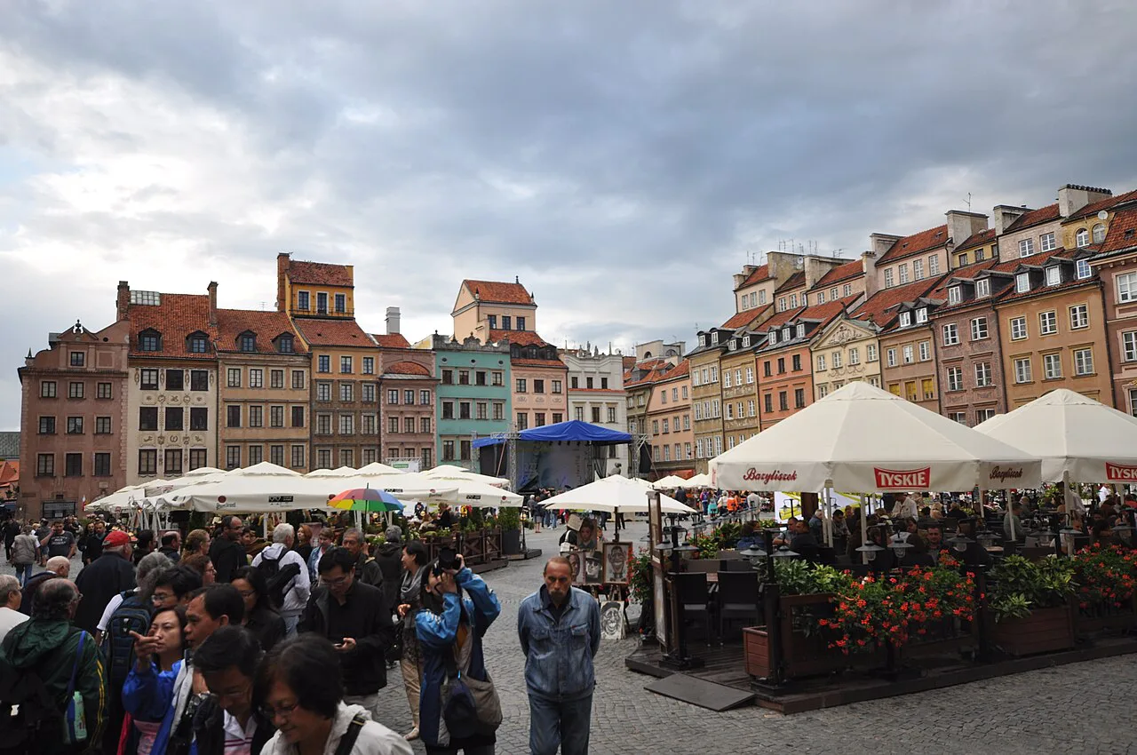 Visitors and café terraces on Warsaw's Old Town Market Place.