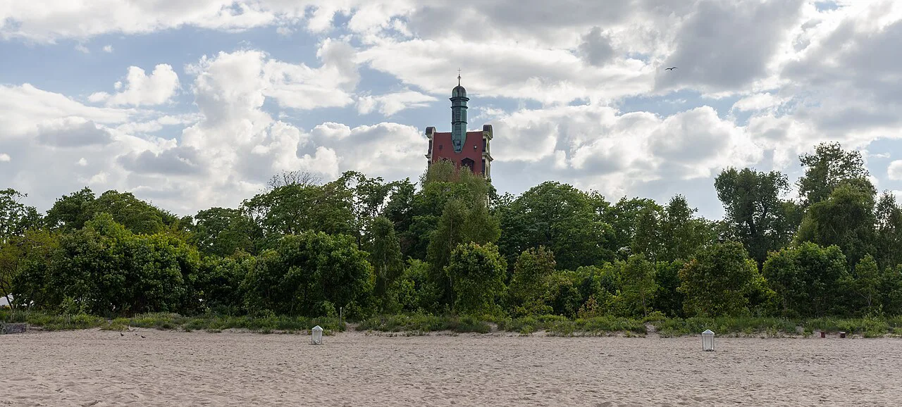 The tower of the Lutheran church in Sopot seen beyond the trees.