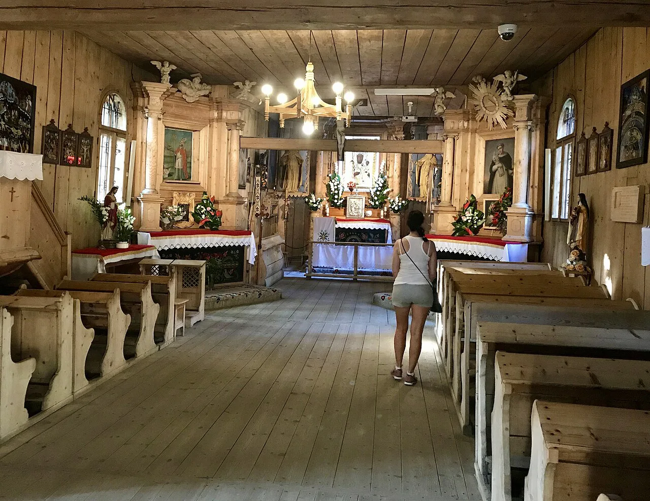 Wooden pews and altar in the old Church of Our Lady of Częstochowa and St Clement in Zakopane.