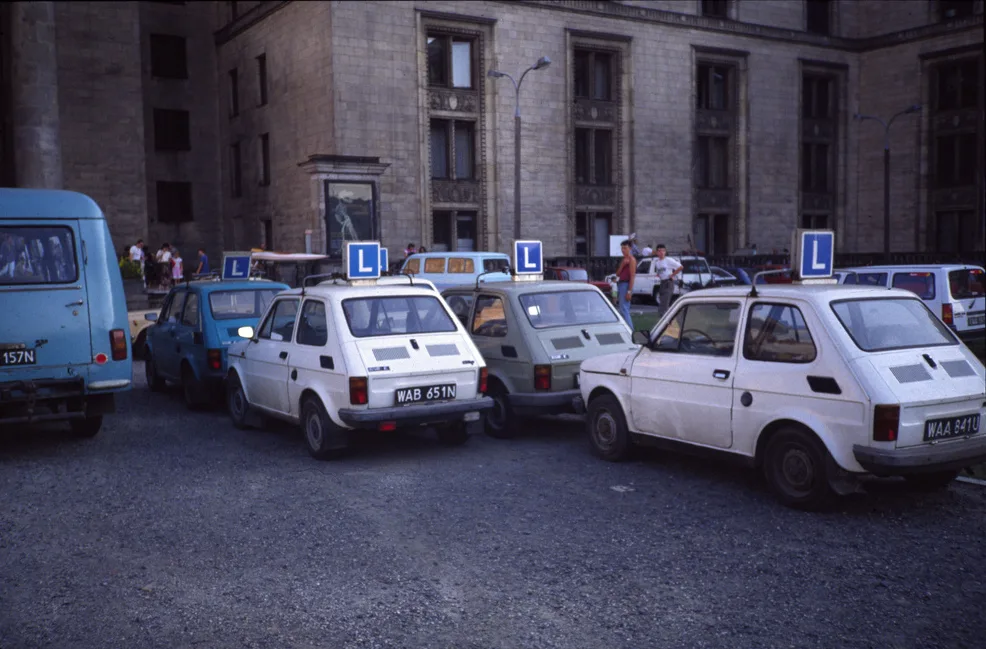Polski Fiat 126p driving-school cars parked at the Palace of Culture and Science in Warsaw.
