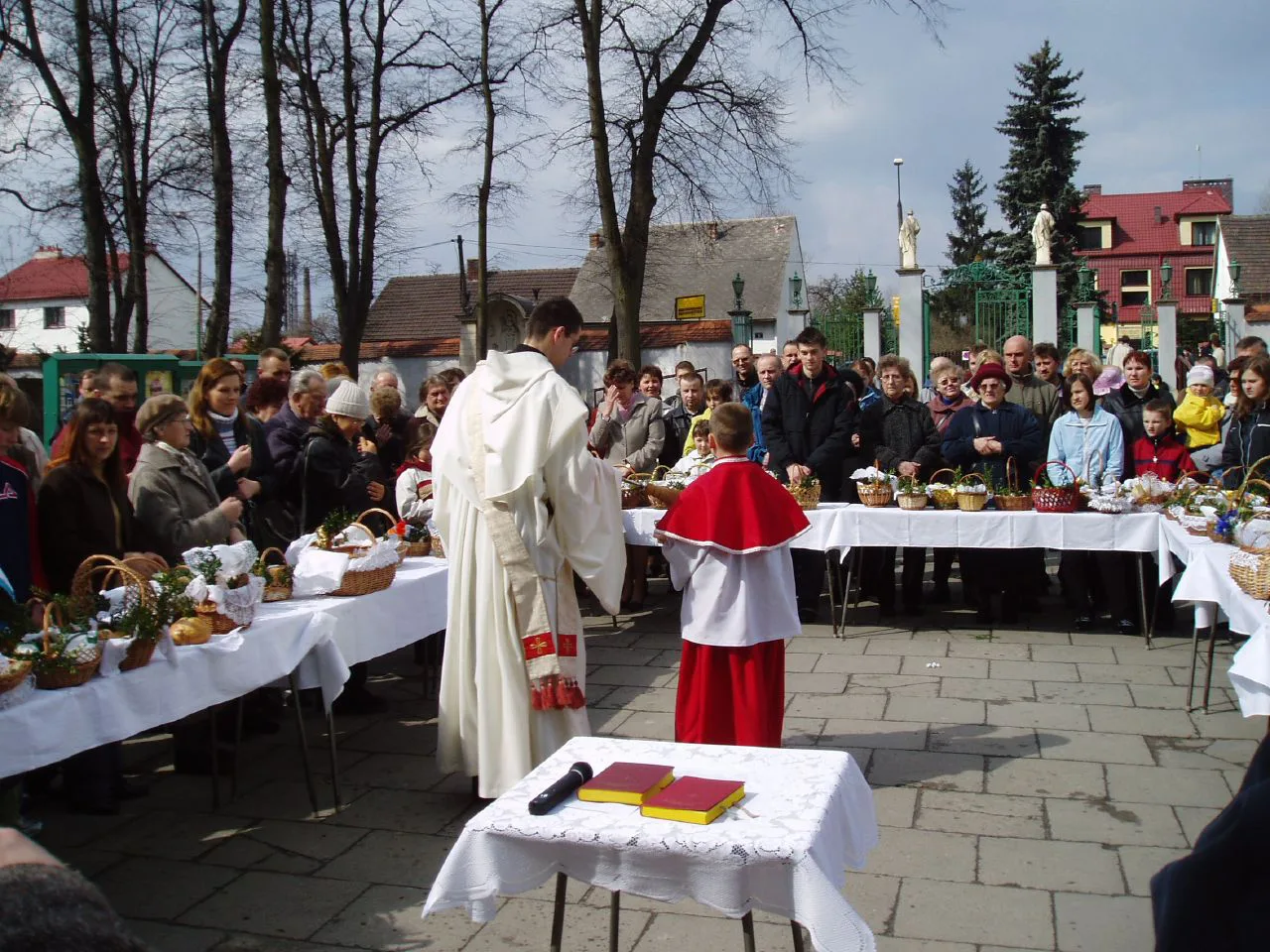 A priest blessing Easter baskets.