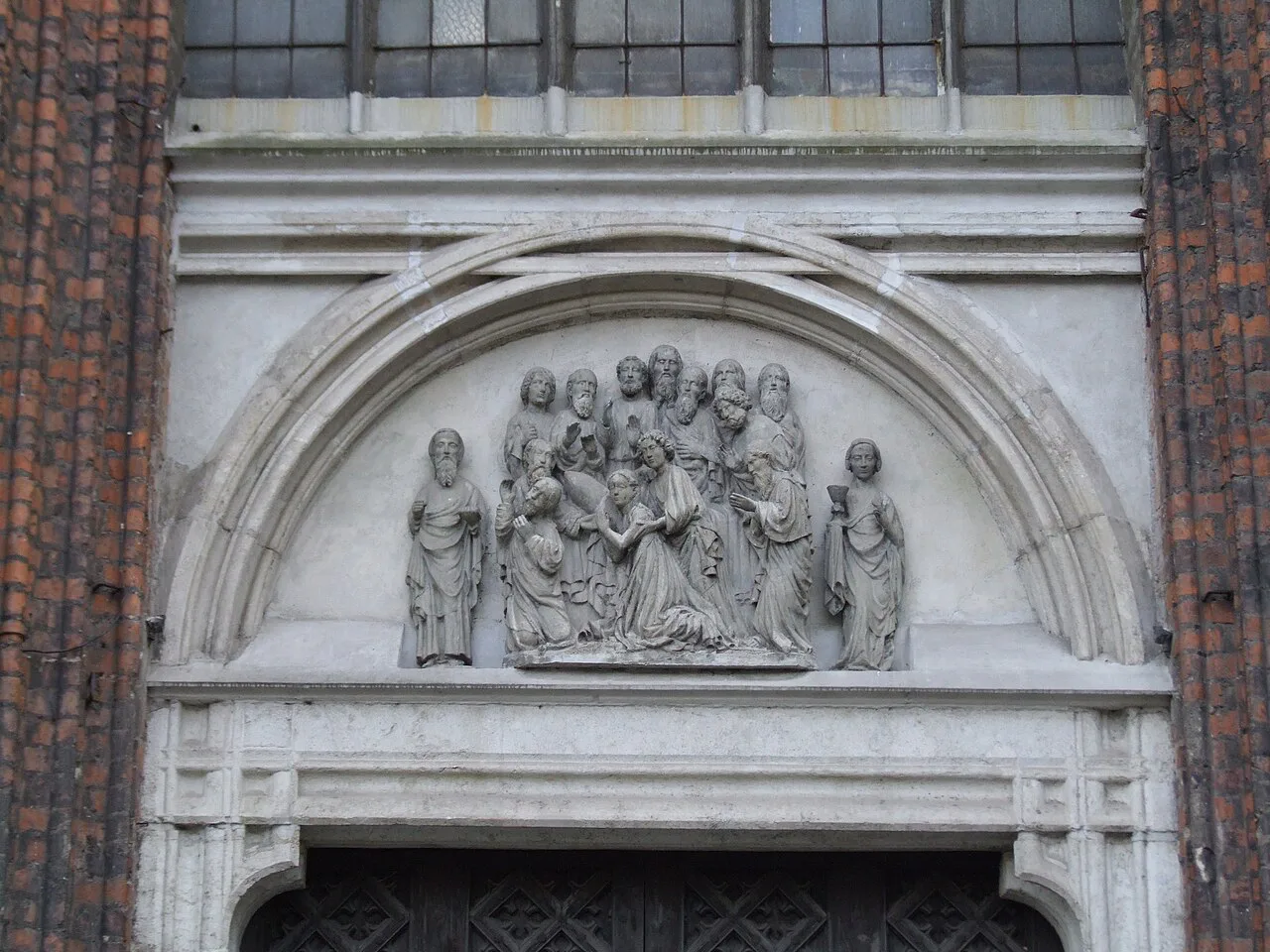 Sculpted tympanum above a side portal of St Mary's Church in Gdańsk.
