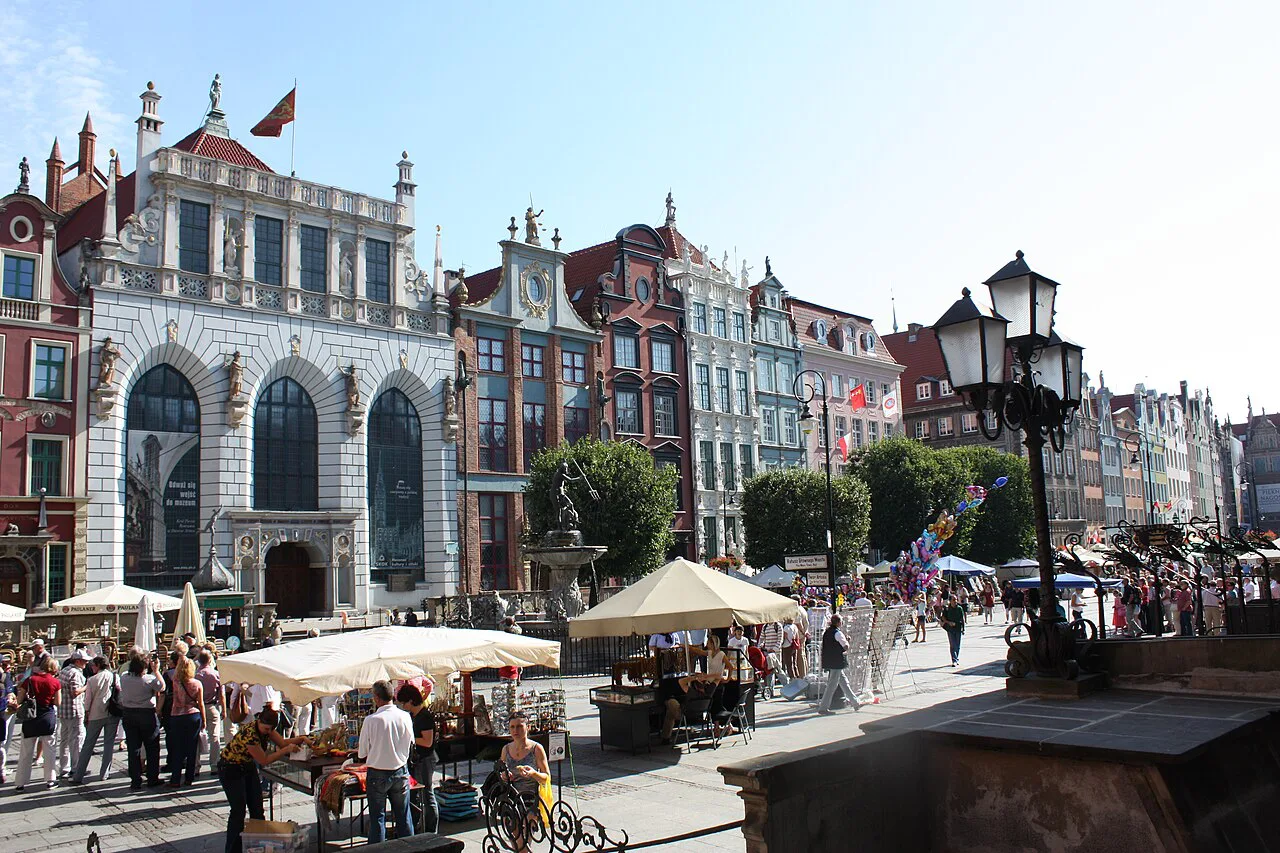 Café umbrellas and historic facades on Long Market in Gdańsk.