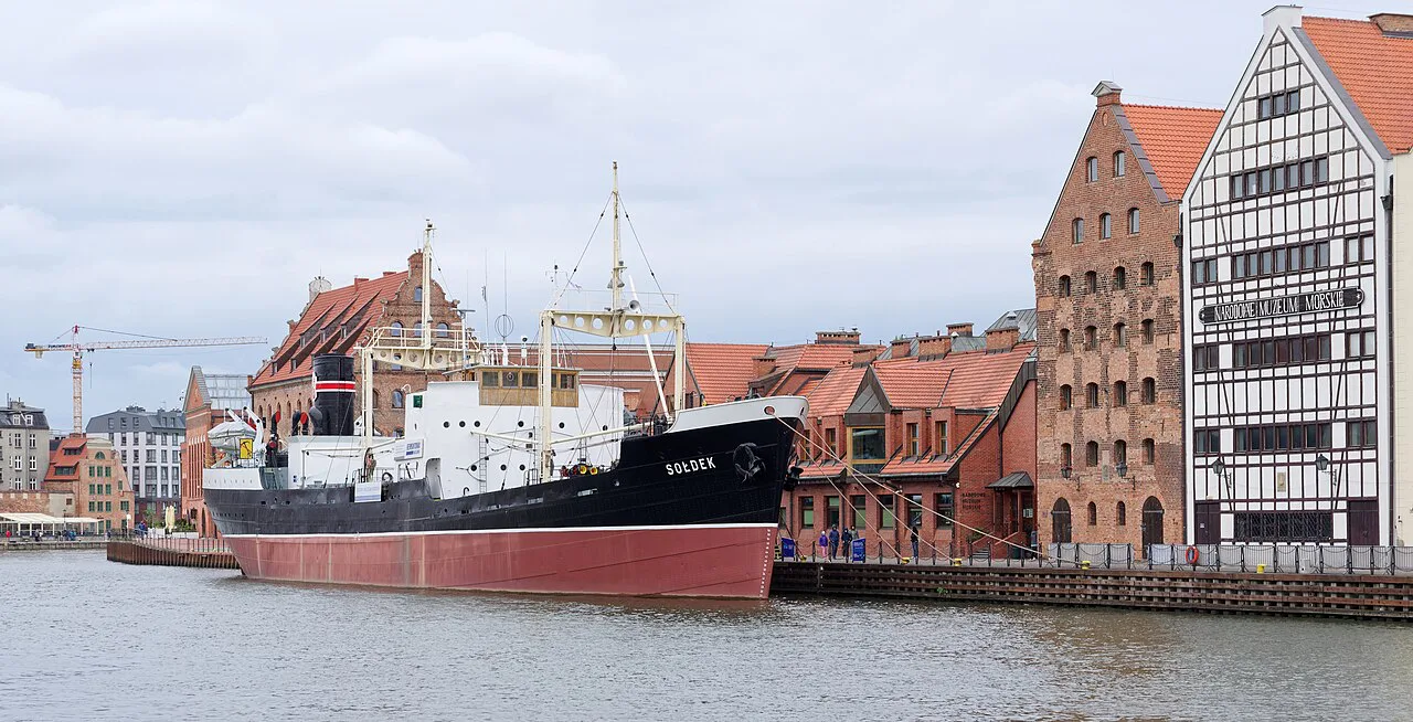 National Maritime Museum buildings and a moored ship on the Motława in Gdańsk.