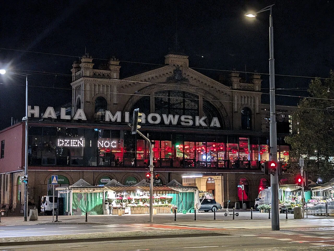Hala Mirowska, a historic market hall in central Warsaw, at night.