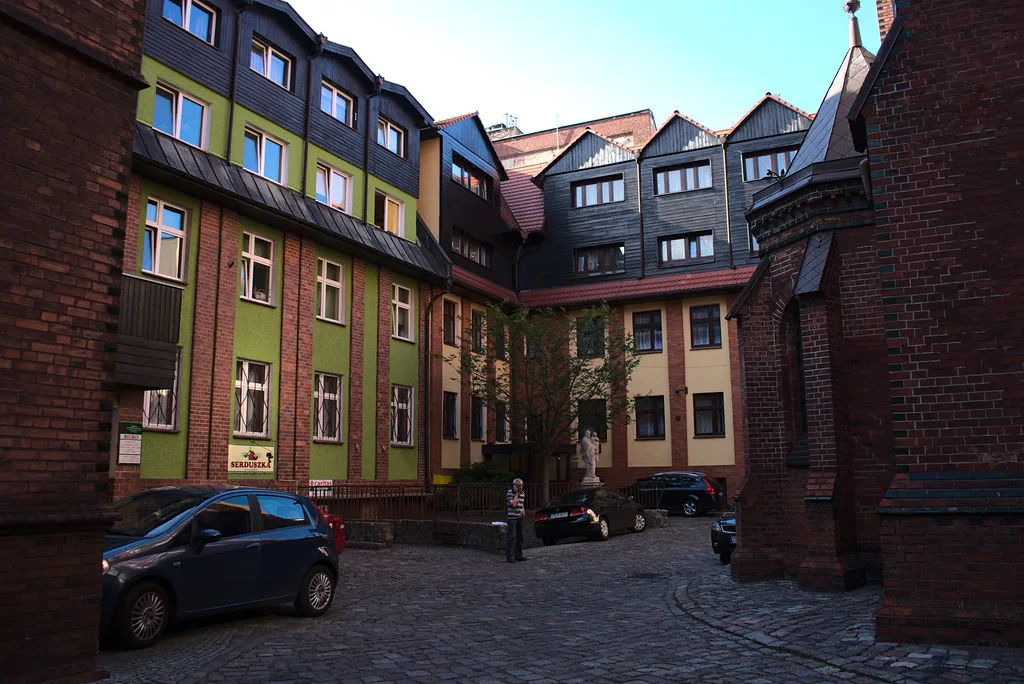 Red-brick buildings around a courtyard in Szczecin.