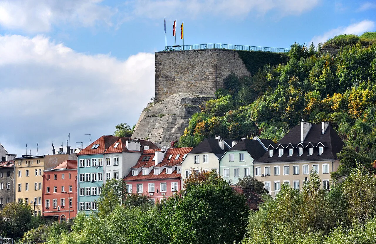 Kłodzko Fortress rising above townhouses.