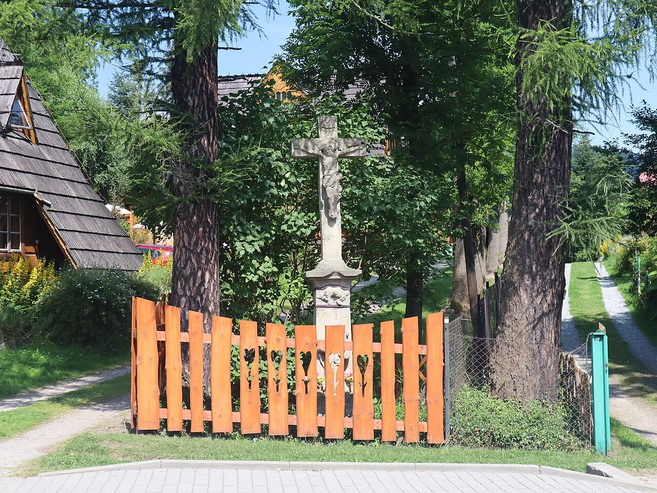 A stone roadside cross on Krzeptówki Street in Zakopane.