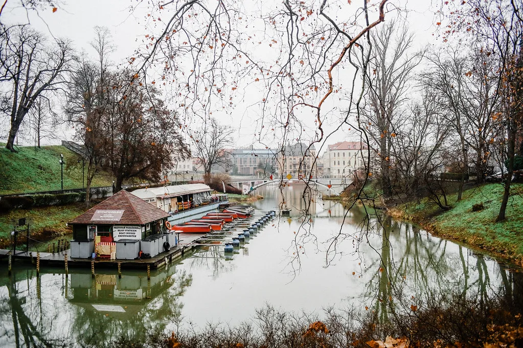 Boats moored on a river channel in Wrocław in winter.