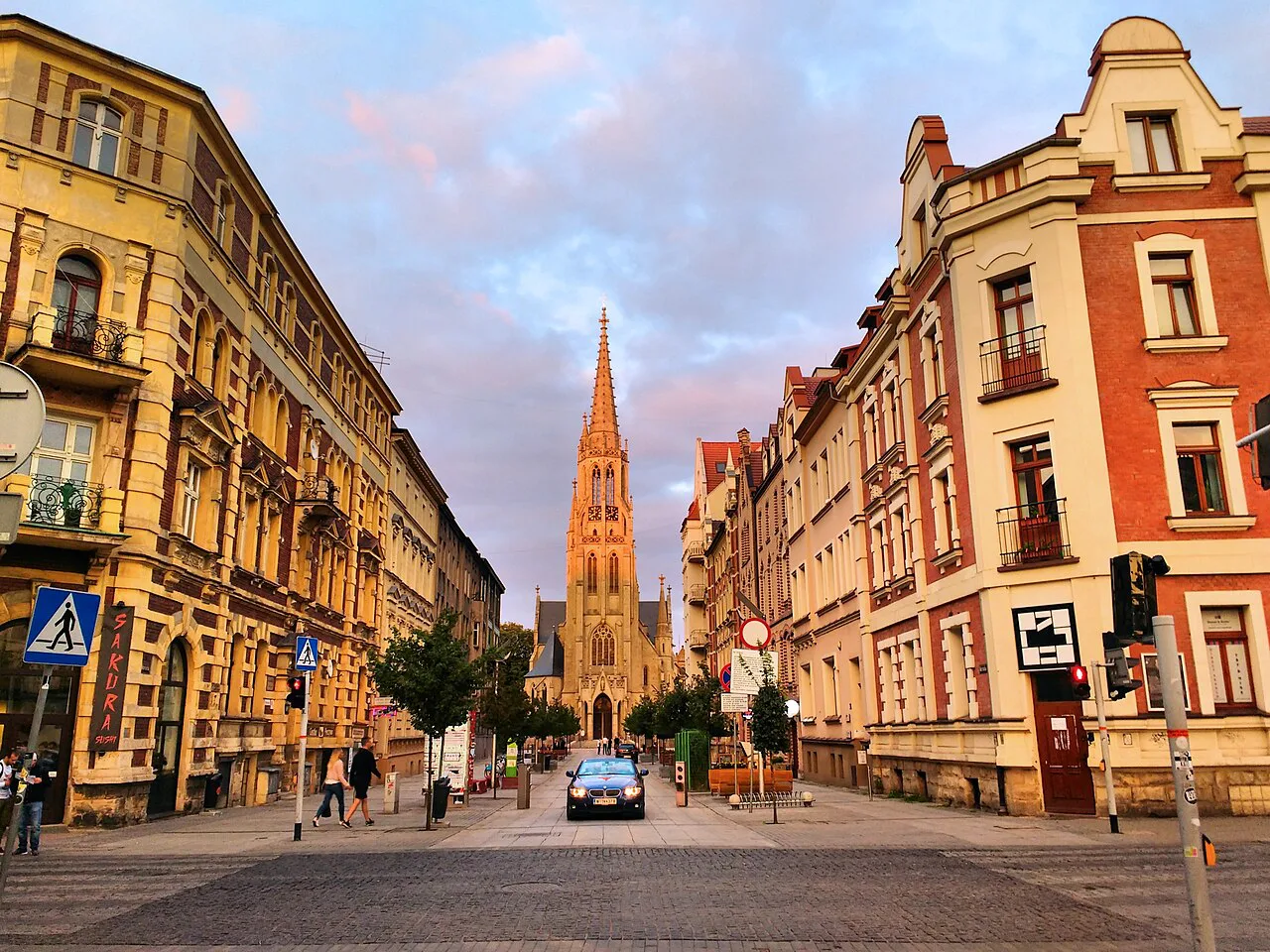 Mariacka Street in Katowice at sunset, with St Mary's Church at the end of the street.