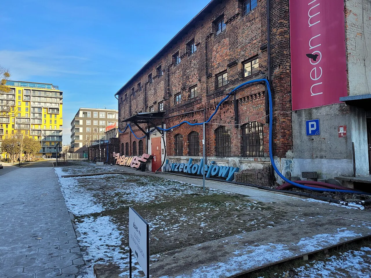 The Neon Museum building at Soho Factory in Warsaw, with old neon letters along its wall.