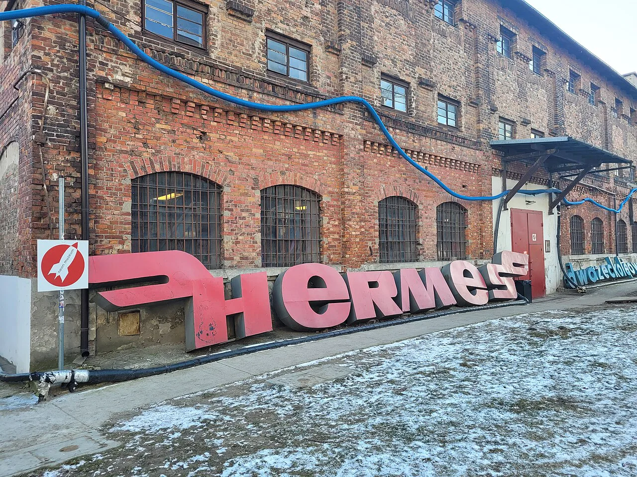 A salvaged Hermes neon sign outside the Neon Museum at Soho Factory in Warsaw.