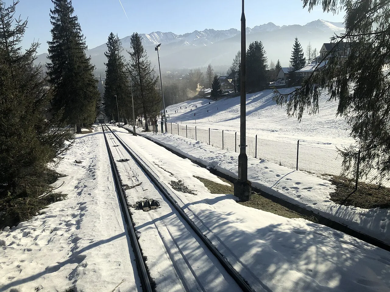 The Gubałówka funicular track in winter, with the Tatra Mountains on the horizon.
