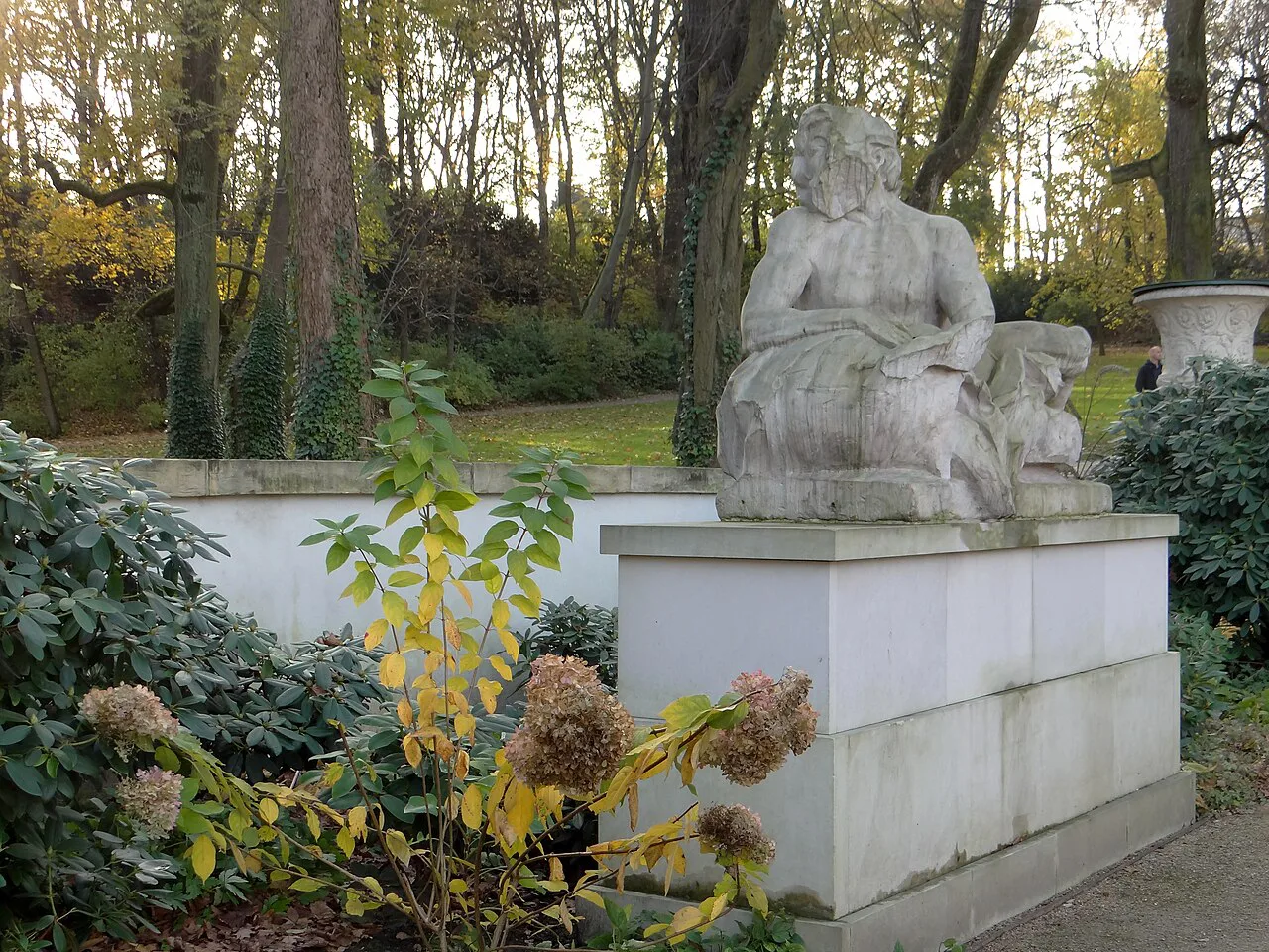 Sculpture among autumn plants at the Old Orangery in Łazienki Park, Warsaw.