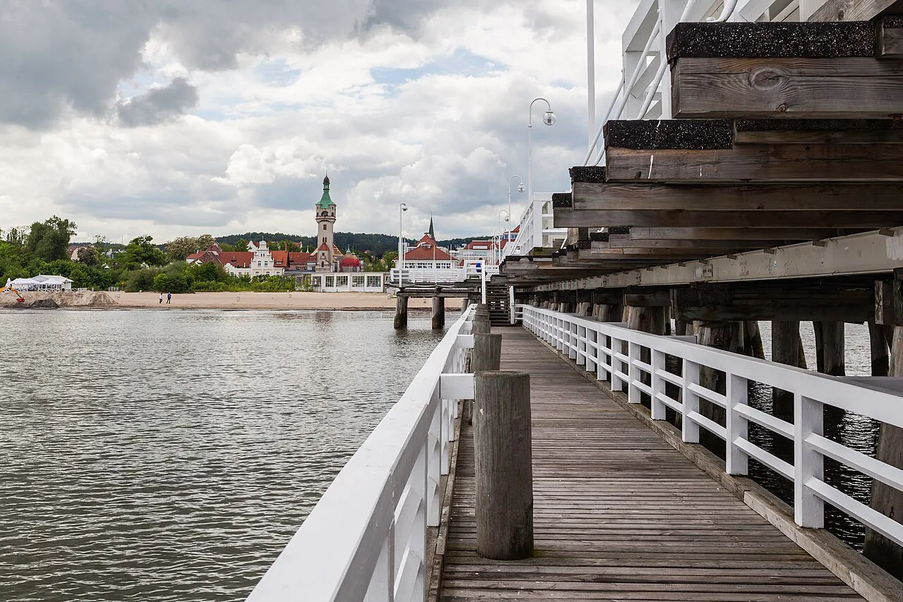 View along Sopot pier towards the shore and the lighthouse.
