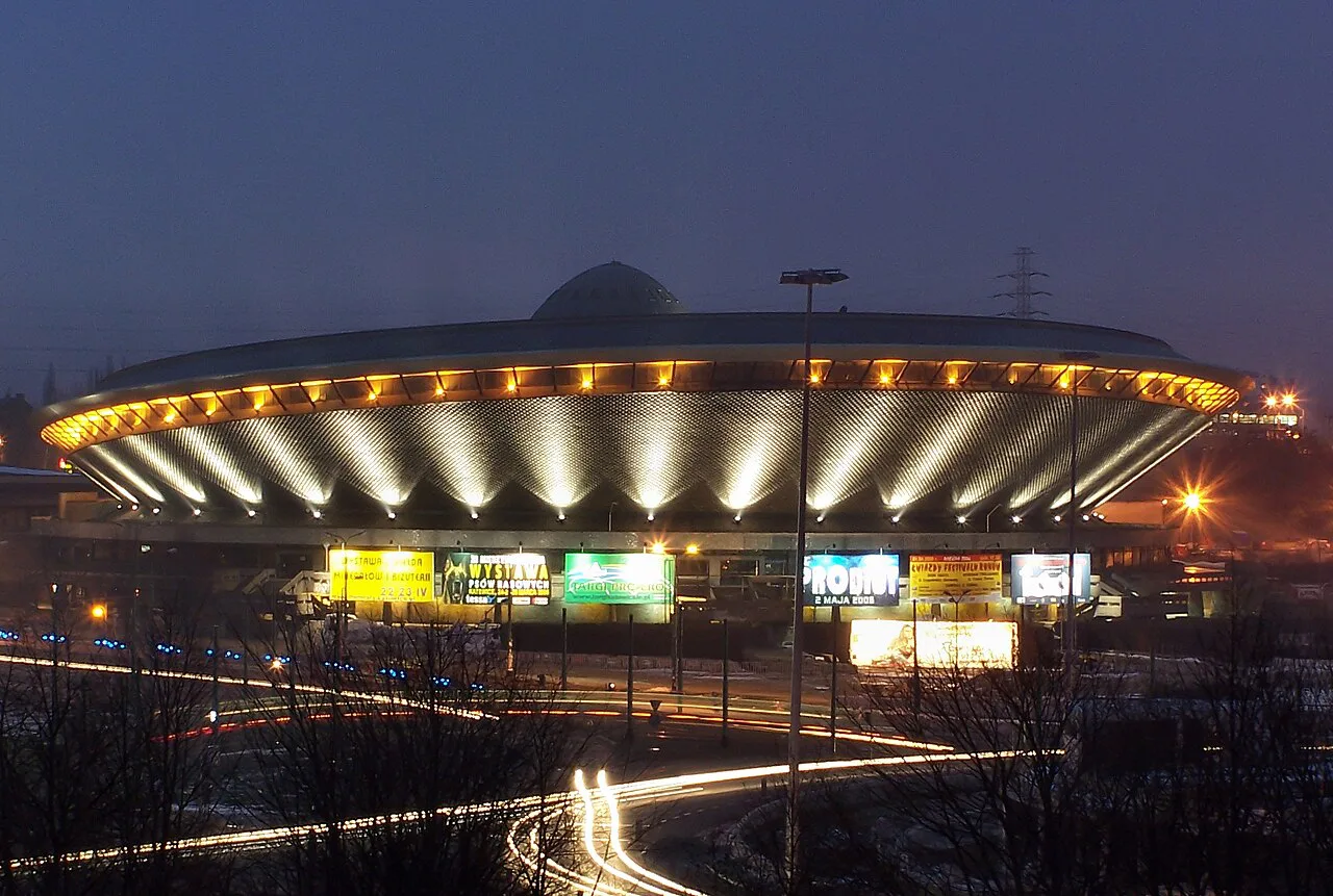 The Spodek arena lit up at night in Katowice.