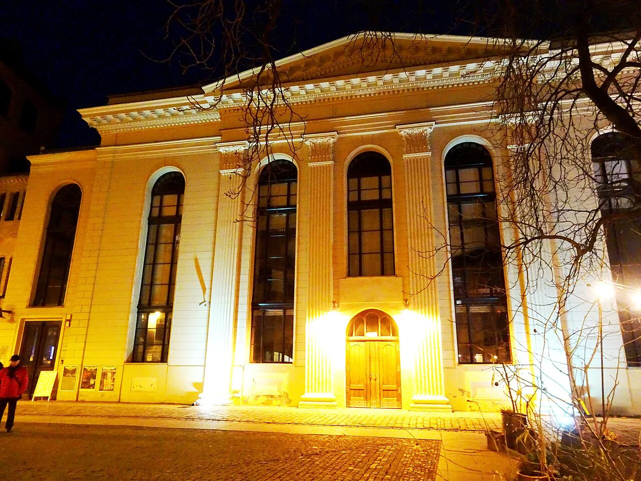 The White Stork Synagogue in Wrocław lit up at night.