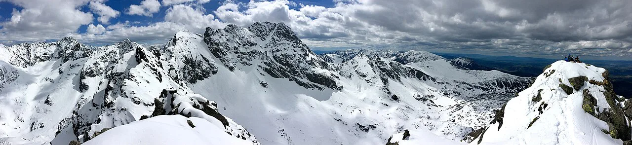 Panoramic view of snowy Tatra peaks from Kościelec in the Tatra National Park.