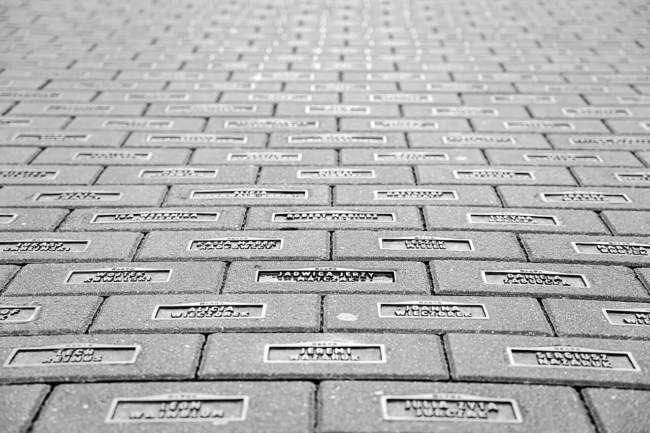 Inscribed memorial bricks paving Piotrkowska Street in Łódź.