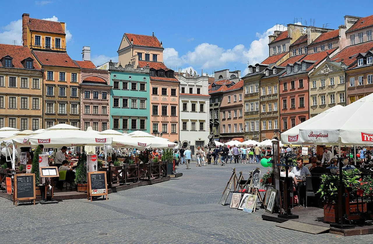 Café terraces and art stalls on Warsaw's Old Town Market Square.