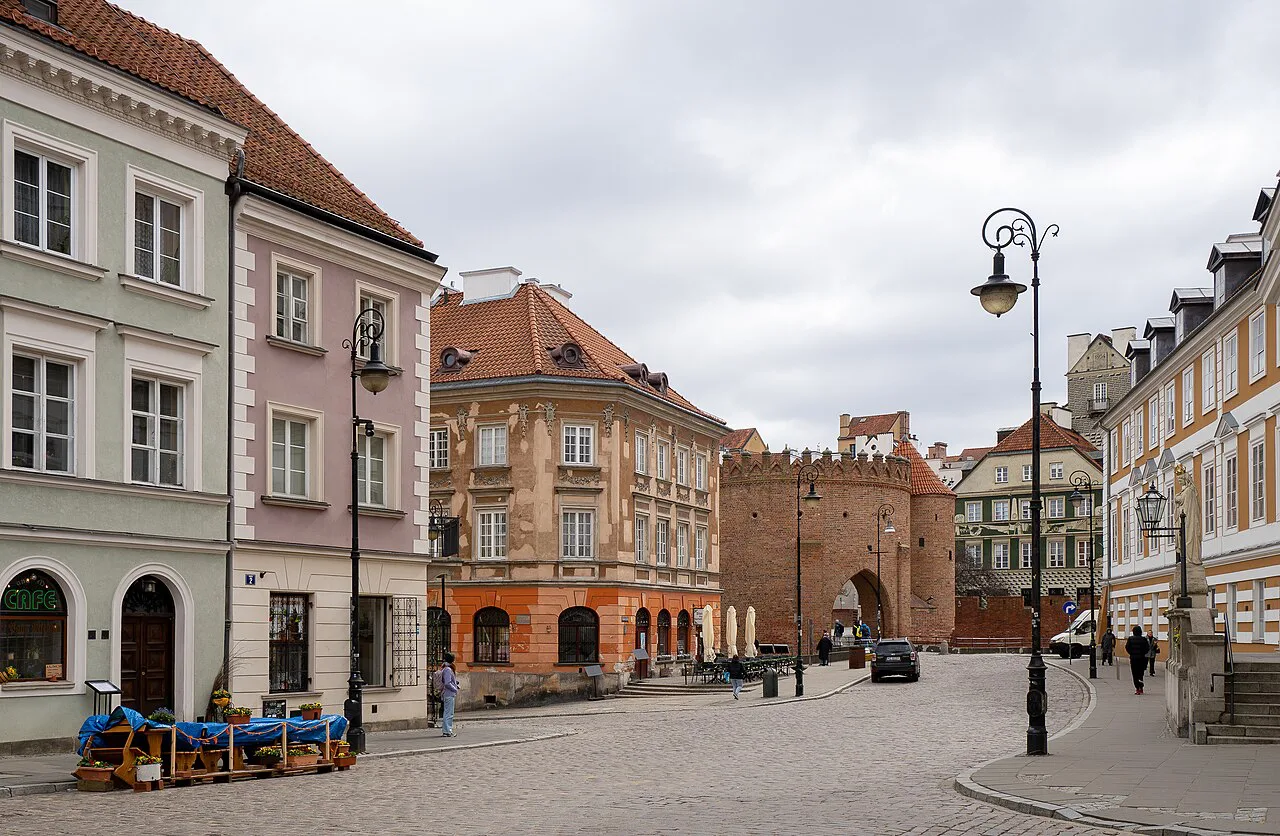 Nowomiejska Street in Warsaw's Old Town under a grey sky.