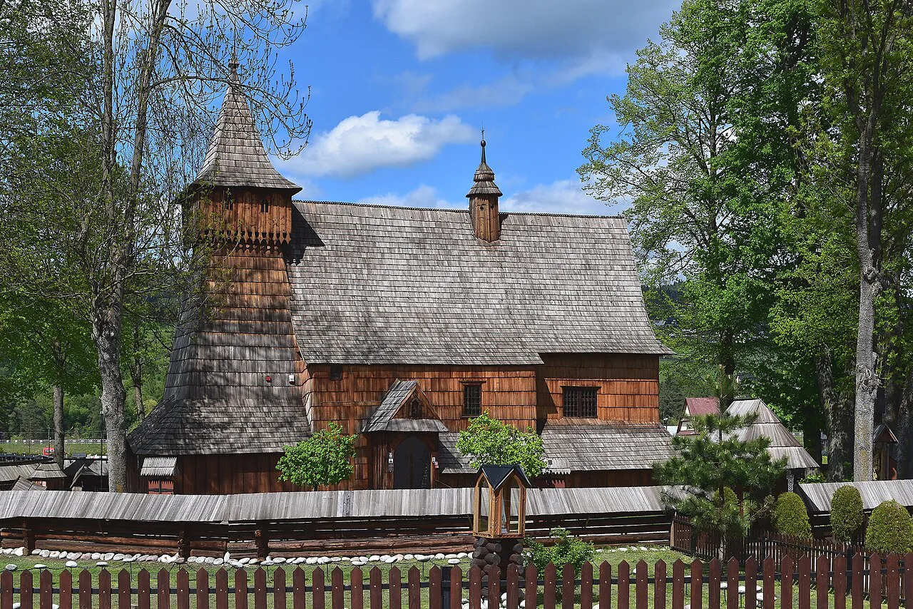 St Michael's wooden church in Dębno behind its fence.