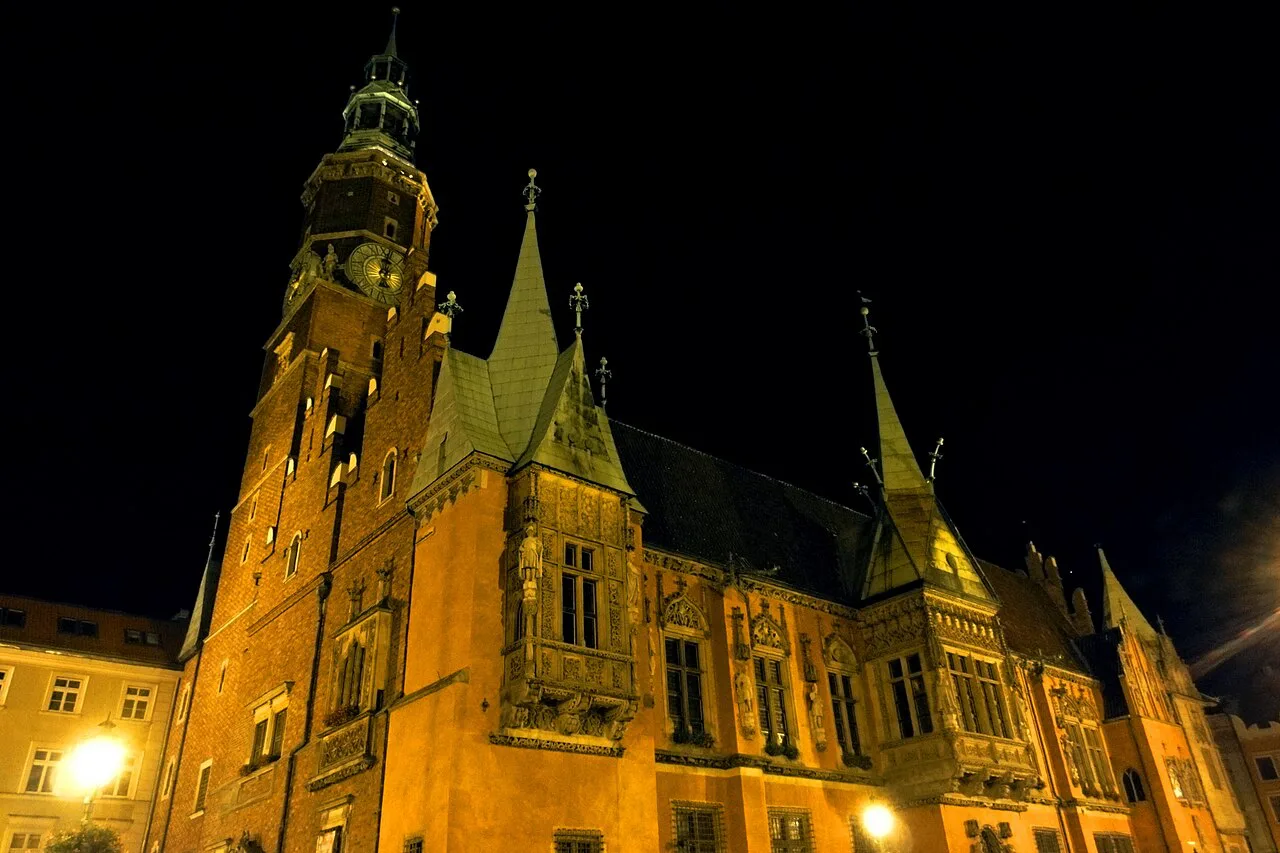 Wrocław's Old Town Hall lit up at night.