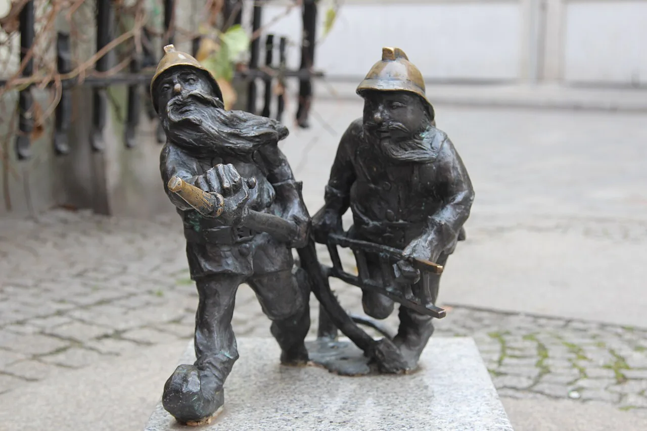 Firemen dwarf figures near St Elizabeth's Church in Wrocław.