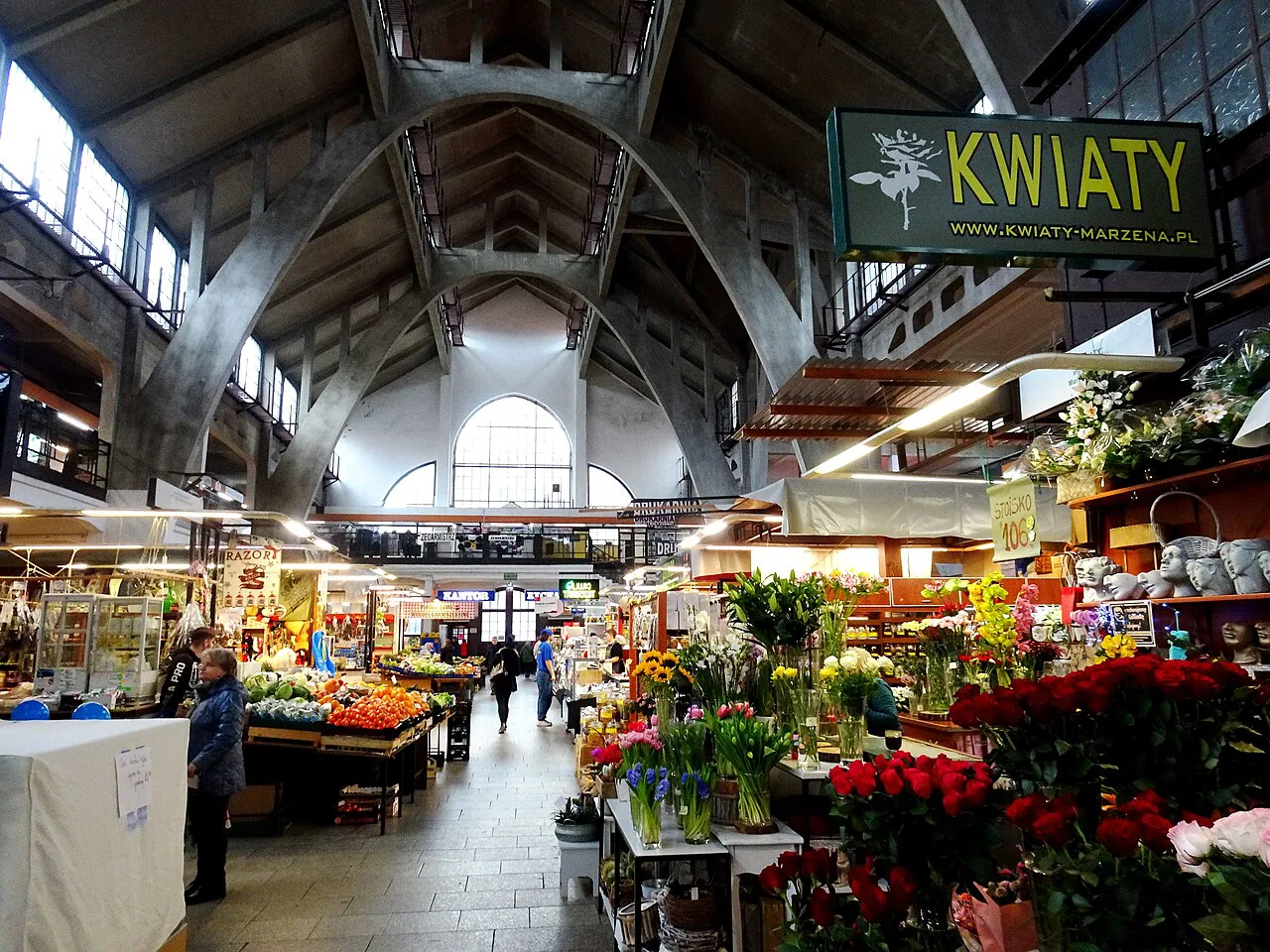 Flower and produce stalls inside Wrocław Market Hall.