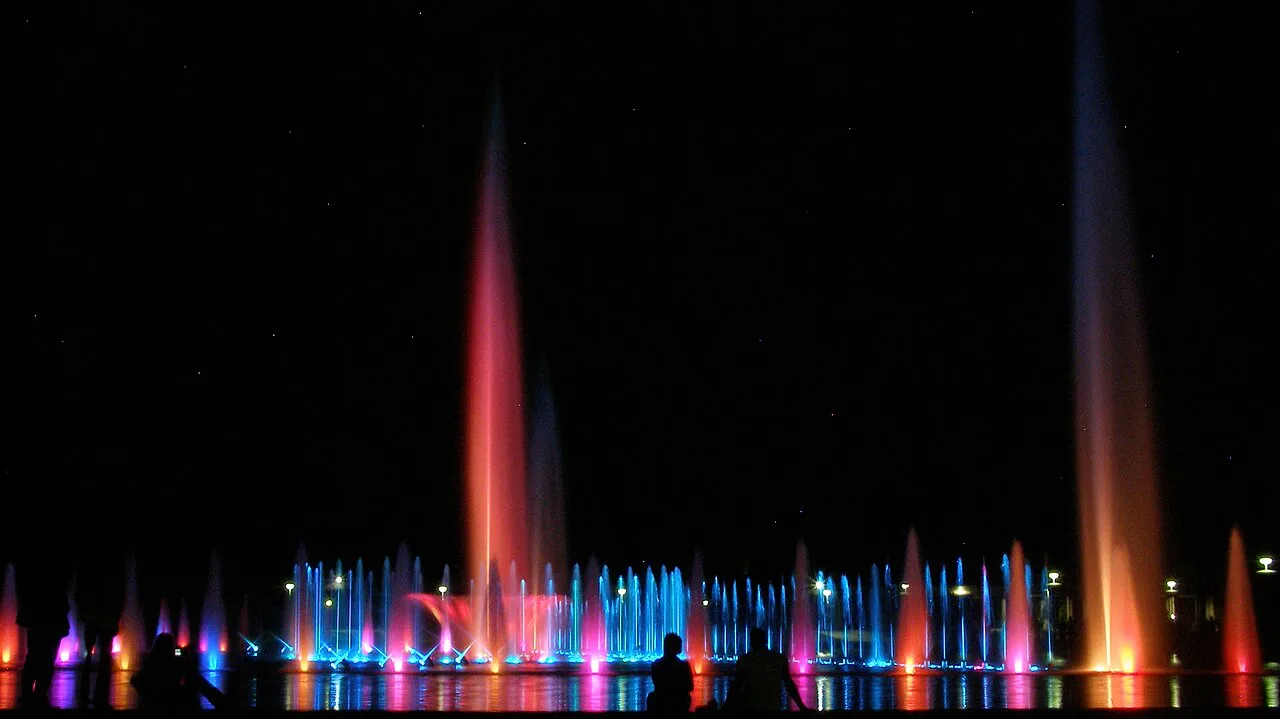 Coloured jets of the Wrocław Multimedia Fountain at night.