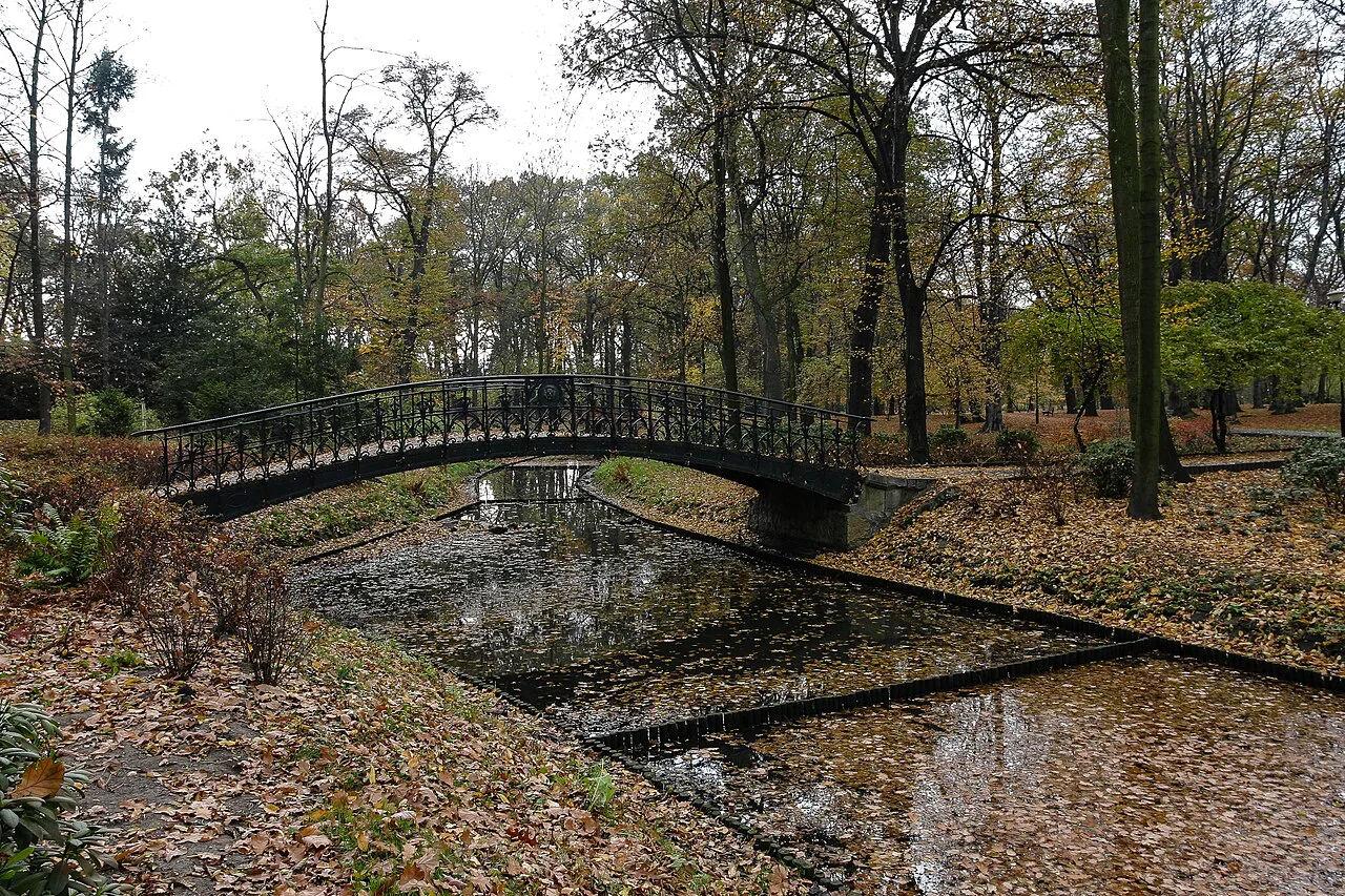 A footbridge over a stream in Szczytnicki Park, Wrocław, in autumn.