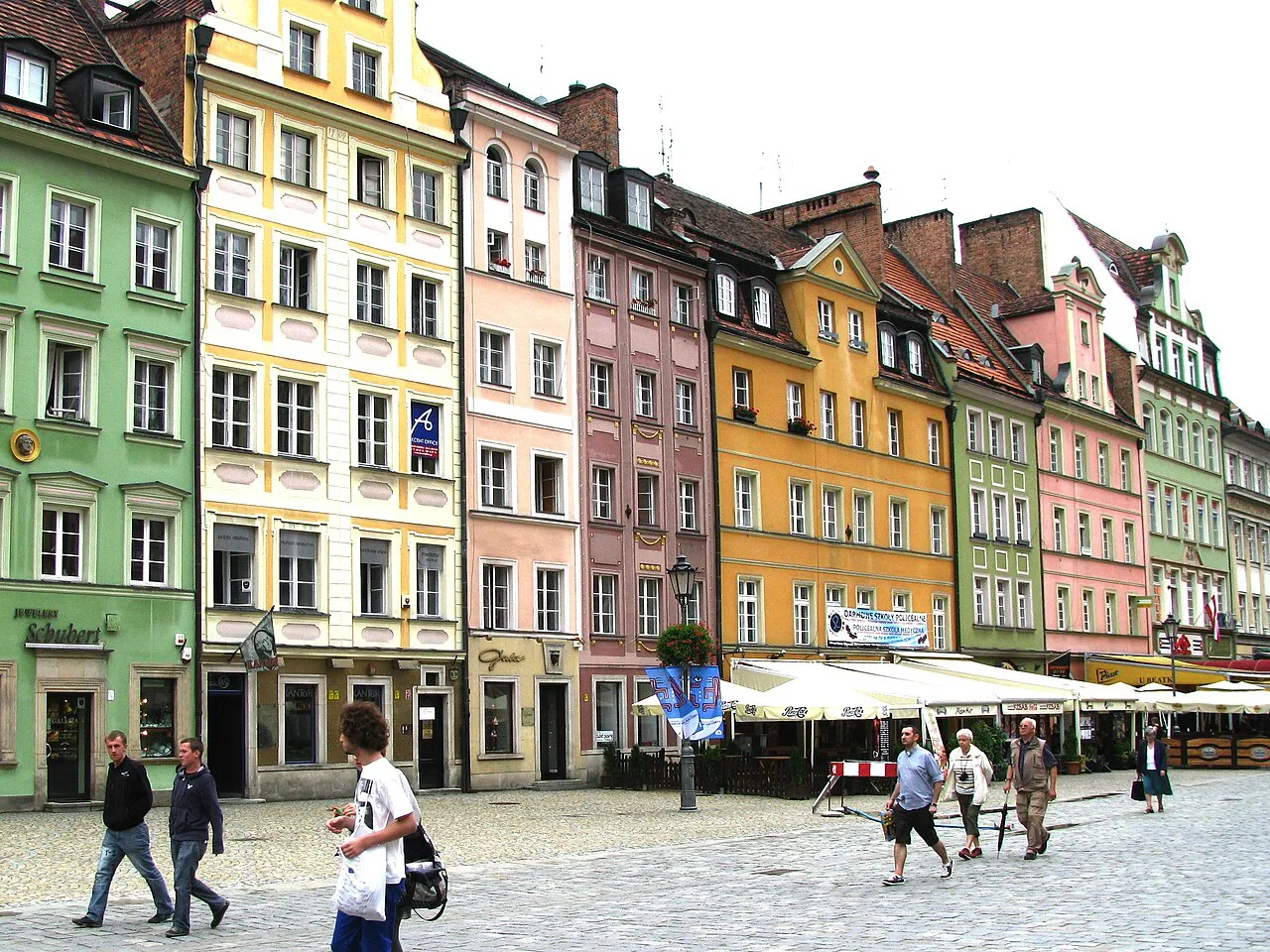 Café terraces below townhouses on the Market Square in Wrocław.
